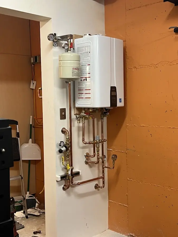 Plumbing technician inspecting water heater connections in Eureka